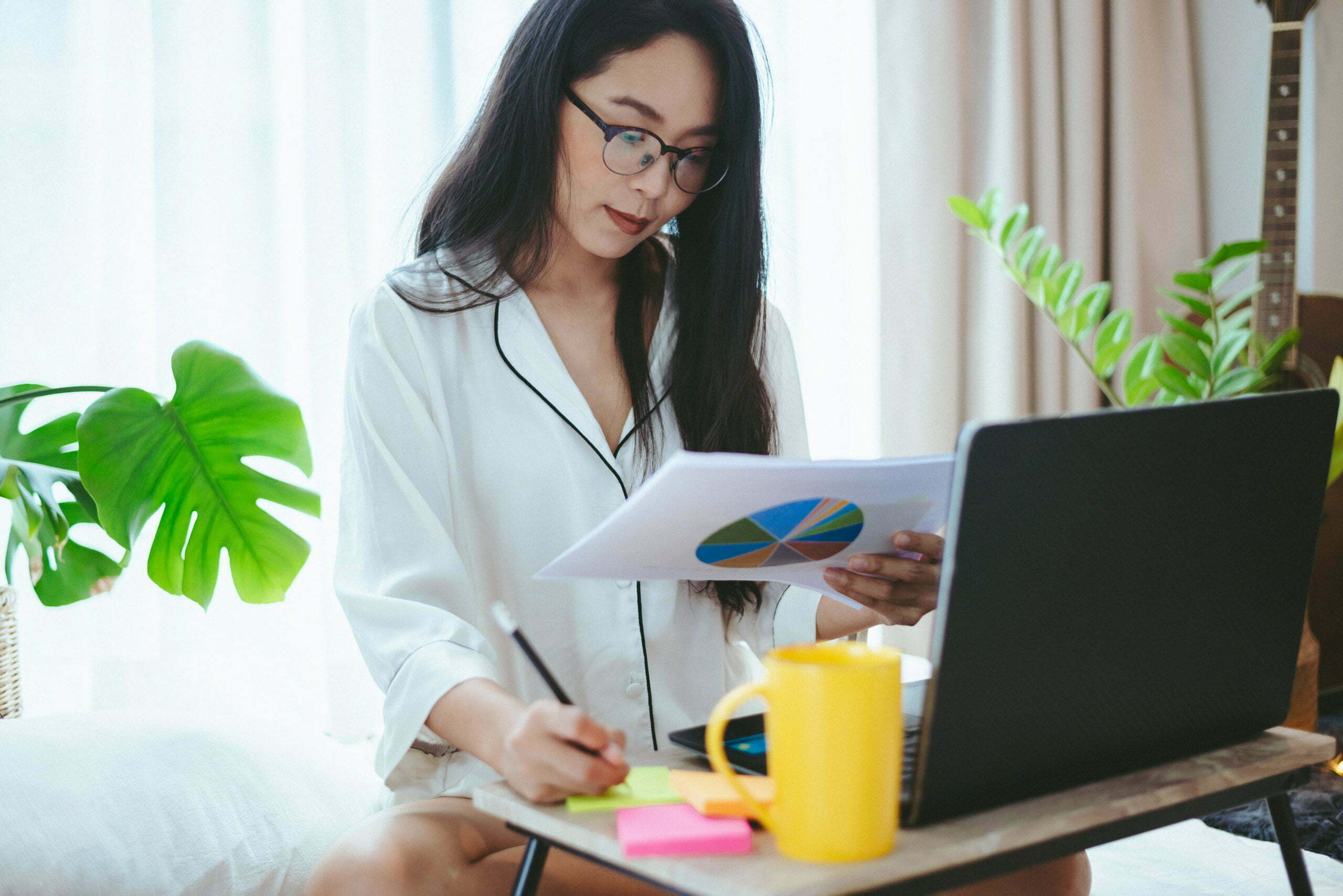 young Asian woman freelance working business work on laptop at home, working from home concept