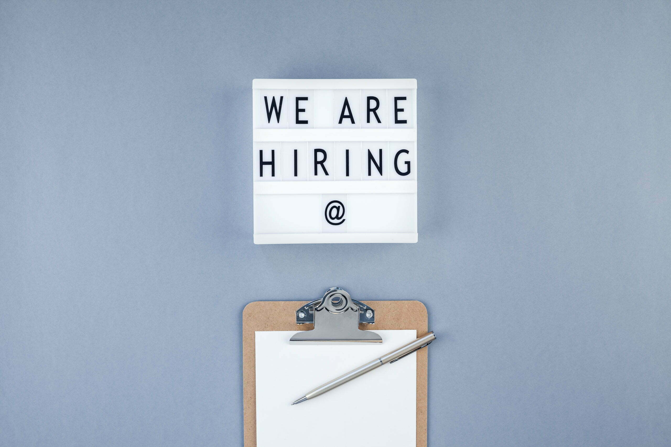 We are hiring flat lay on blue background