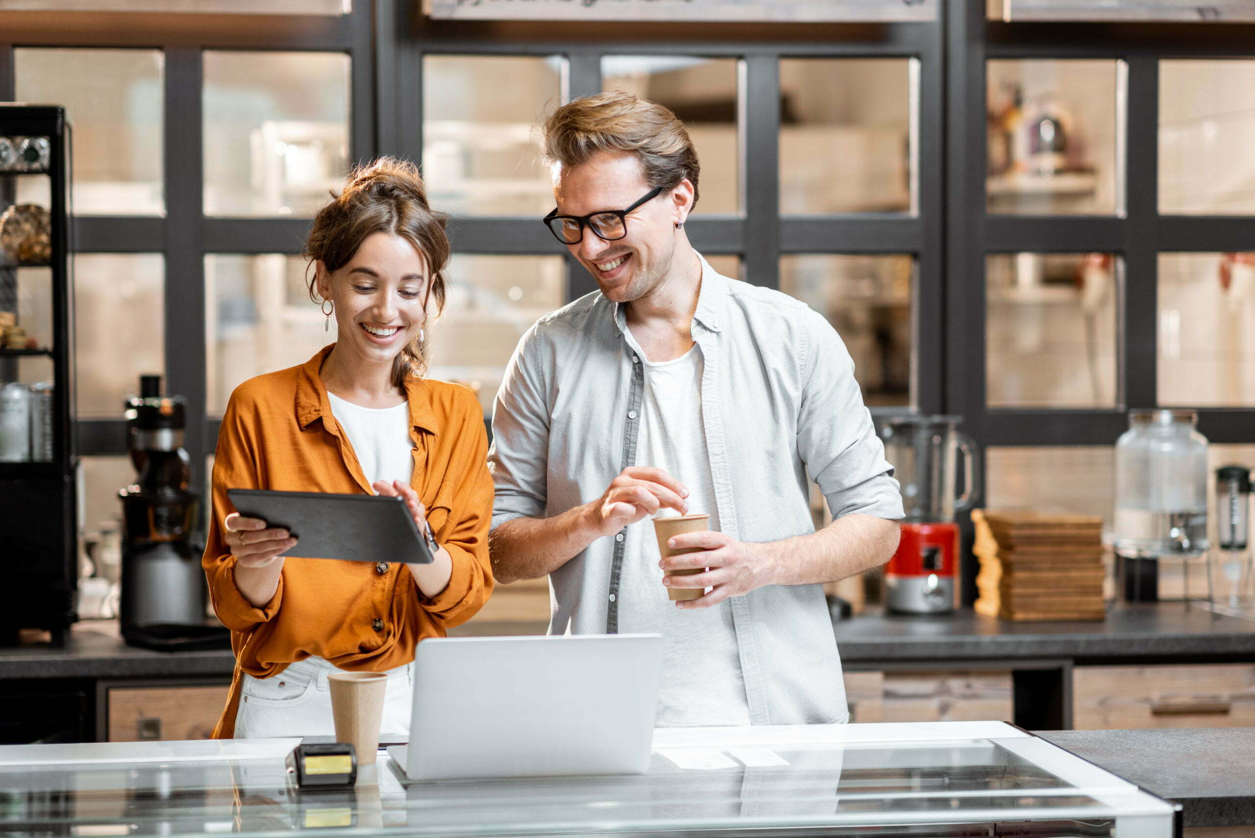 a man and a woman looking at a tablet