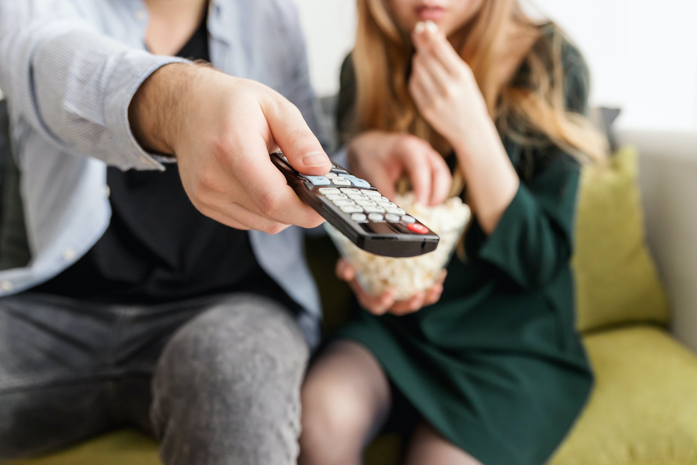 a group of people sitting on a couch with a cell phone