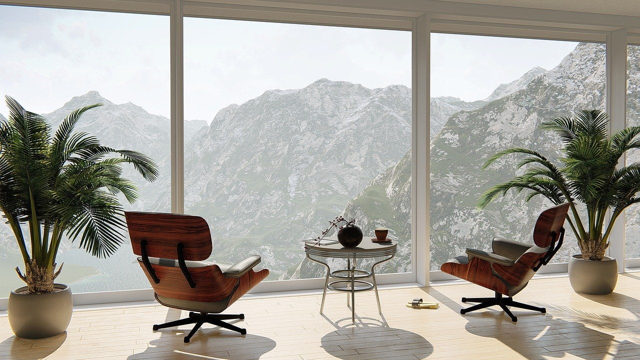 a couple of chairs and a table in a room with a window
