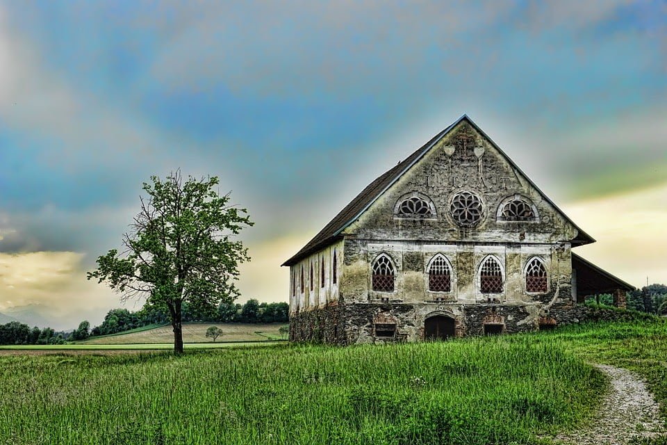 a stone building with a tree in front of it