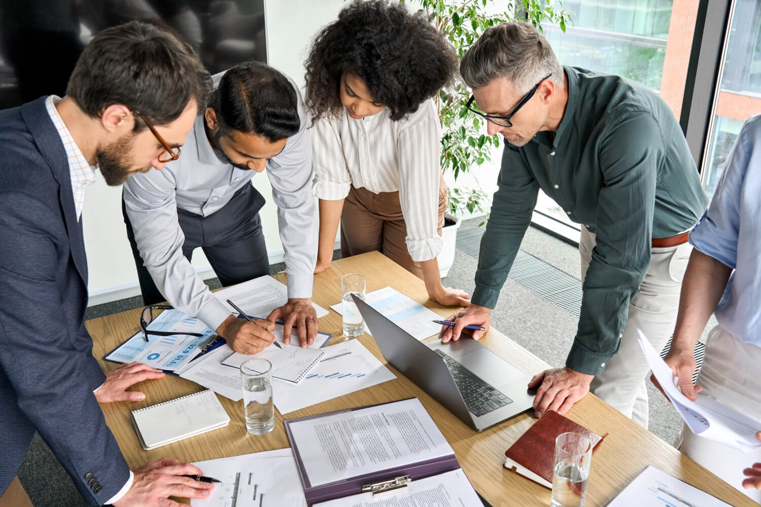 a group of people looking at a laptop